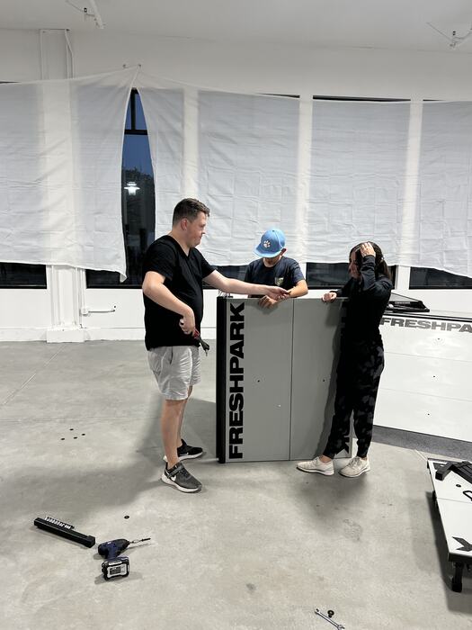 Two people assembling the Freshpark ramps during set-up