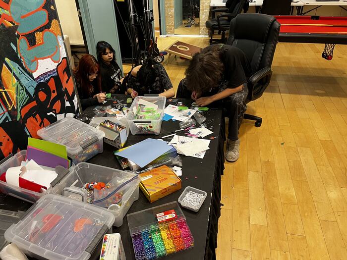 A work table covered in supplies during a class