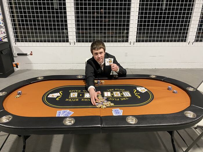 A teen in a blazer at the Life Shop poker table