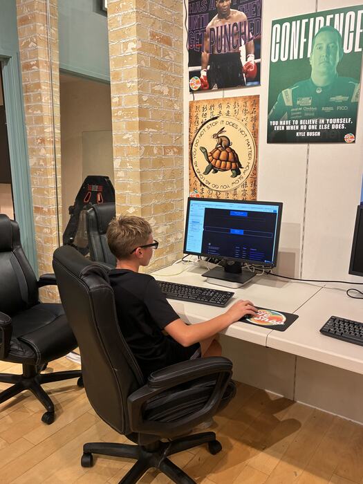 A teen working at one of the Life Shop computers