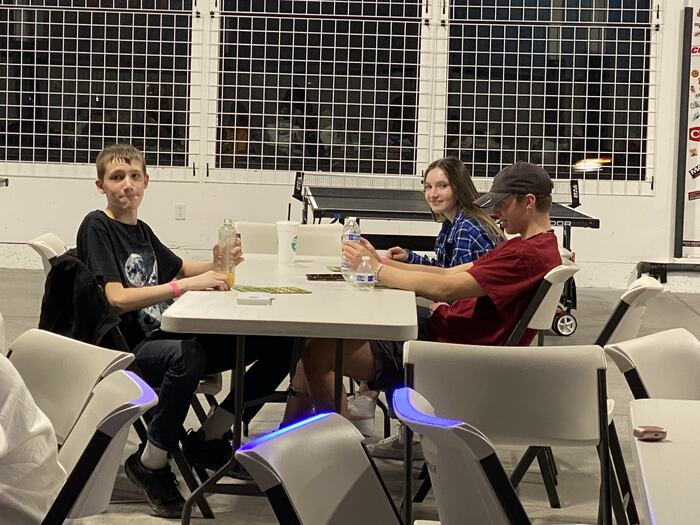 Teens sitting round a table together at Life Shop